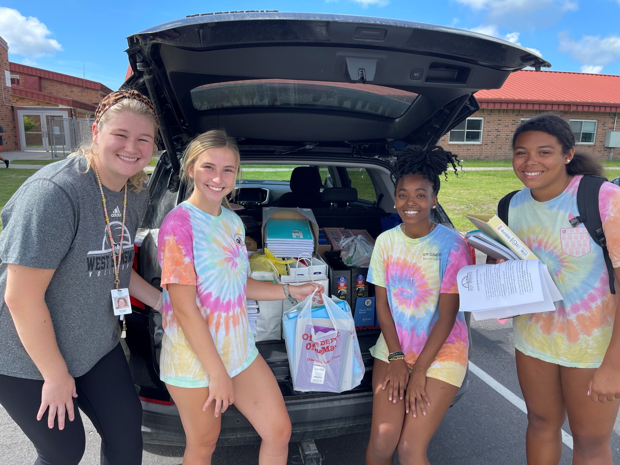 Delivering supplies to West Brunswick High School, with help from the volleyball team